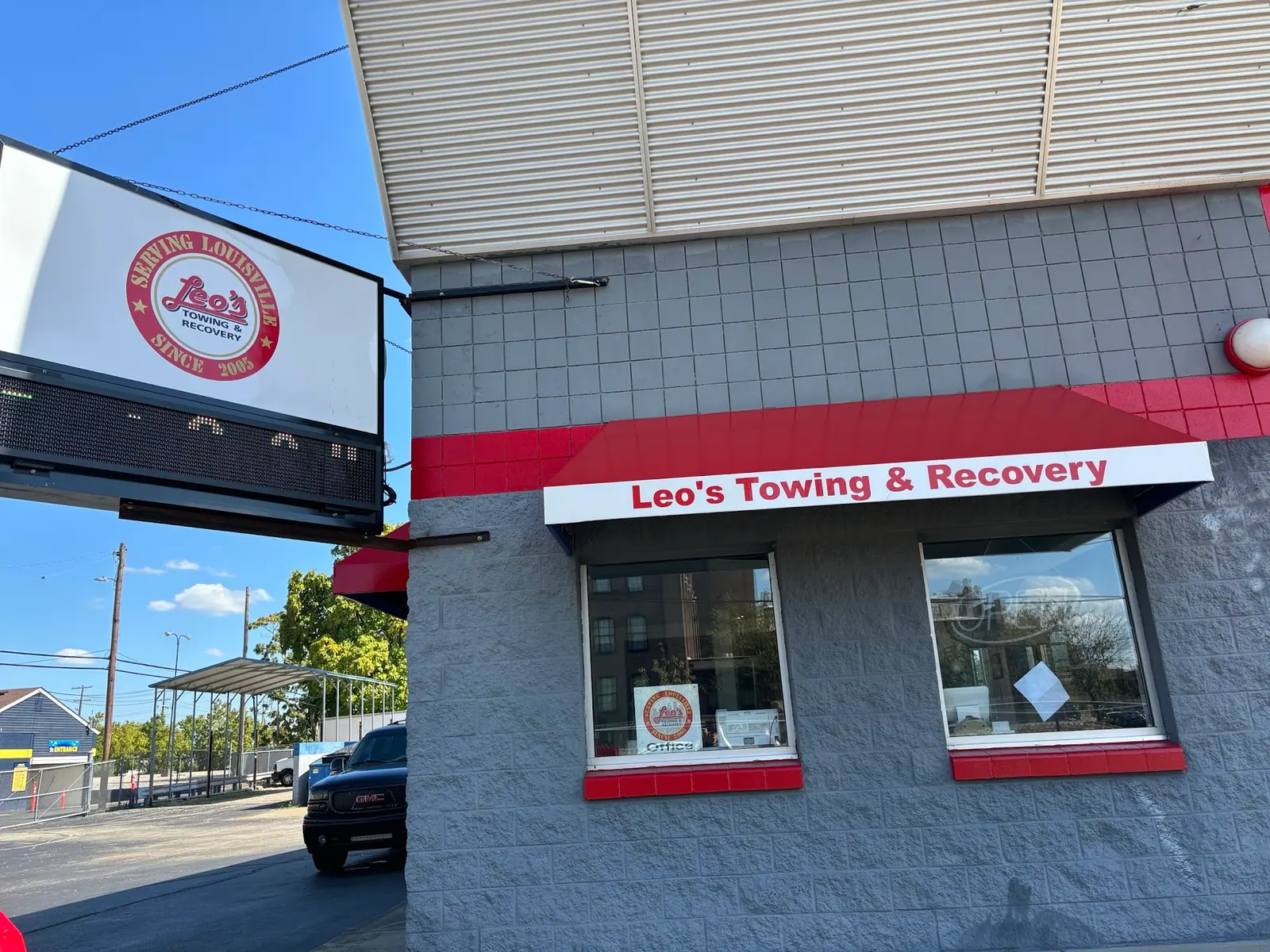 Leo's Towing & Recovery storefront with its hanging sign